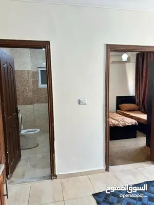 a bathroom with a door open to a bedroom with a toilet at studio al jubiha 1 استوديو الجبيهة in Amman