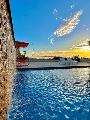 a pool of water with two white benches next to it at sama vailla in Amman