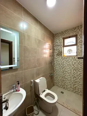 a bathroom with a toilet and a sink and a mirror at sama vailla in Amman