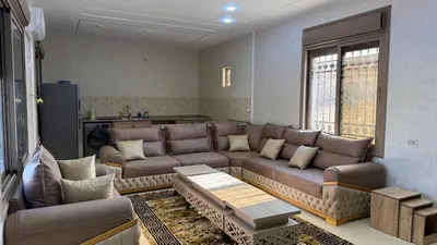 a living room with a couch and a table at شالية جوهرة جراسيا Jewel of Gracia Chalet in Jerash