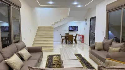 a living room with a couch and a table at شالية جوهرة جراسيا Jewel of Gracia Chalet in Jerash