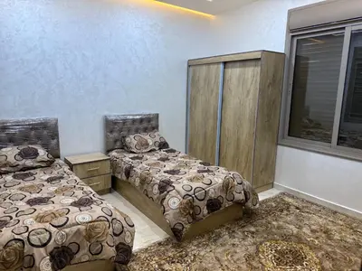 a bedroom with two beds and a window at شالية جوهرة جراسيا Jewel of Gracia Chalet in Jerash