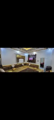 a large living room with a fireplace and a television at شقة مفروشة للإجار in Ar Ramthā
