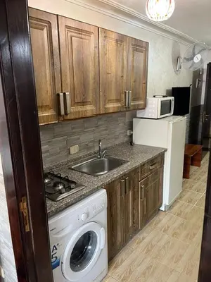 a kitchen with a sink and a washing machine at Central affordable studio in Amman