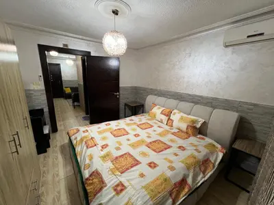 a bedroom with a bed and a room with a hallway at Central affordable studio in Amman