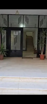 a entrance to a building with stairs and plants at Deluxe Furnished Studio Jubaiha in Amman