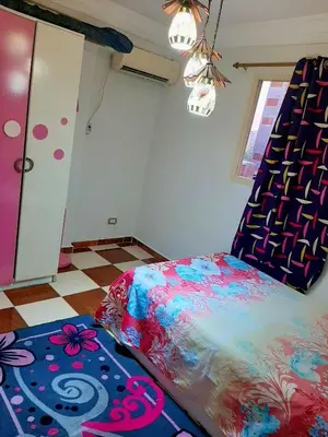 a bedroom with a bed and a checker floor at اهلا وسهلا في الاردن in Petra