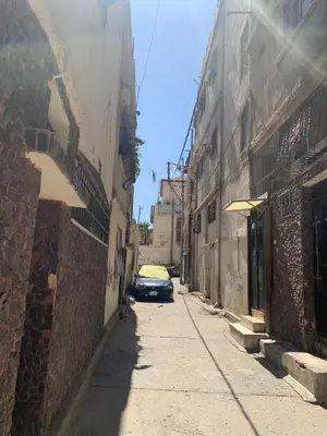 a car parked on a street in an alley at Affordable Furnished 2BR for Rent in Amman