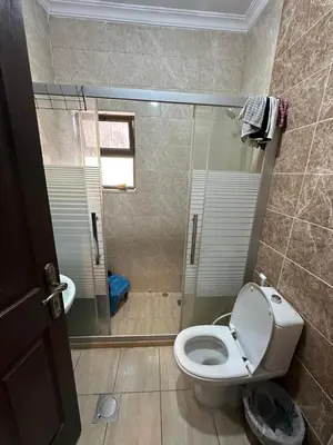 a bathroom with a shower and a toilet in it at MK5 - One bedroom Apartment in Amman