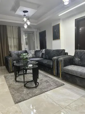 a living room with a couch and a table at EVANNA SUITE & HOTELs VIP ايفانا للشقق الفندقيه VIP in Amman