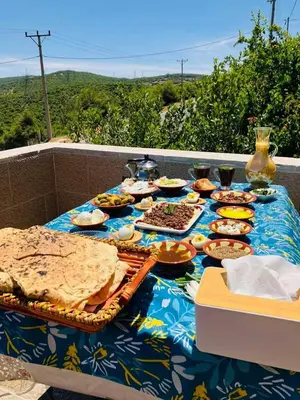 a table full of food on a blue table cloth at Kenda house in Ajloun
