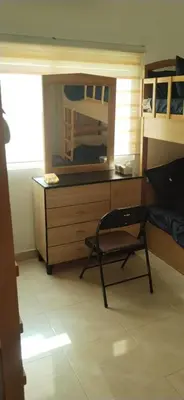 a room with a desk with a chair and a mirror at العقبة in Aqaba