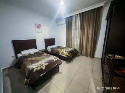 a hotel room with two beds and a window at EVANNA SUITE AND HOTELs ايفانا للشقق الفندقيه و المفروشه in Amman