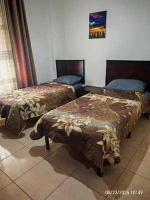two beds sitting next to each other in a room at EVANNA SUITE AND HOTELs ايفانا للشقق الفندقيه و المفروشه in Amman
