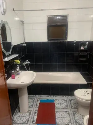 a bathroom with a sink and a tub and a toilet at Hello Hello apartment in Amman