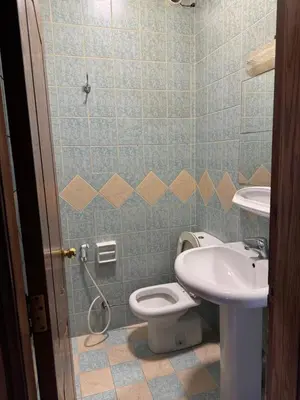 a bathroom with a toilet and a sink at Comfort Apartment in Amman
