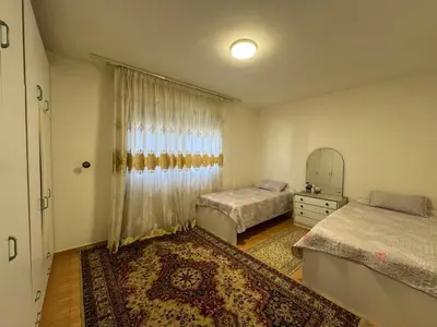 a bedroom with two beds and a mirror at Comfort Apartment in Amman