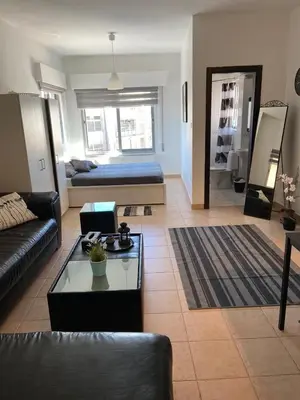 a living room with a couch and a table at Studio for Rent in Jabal Alweibdeh-Amman - Jordan in Amman