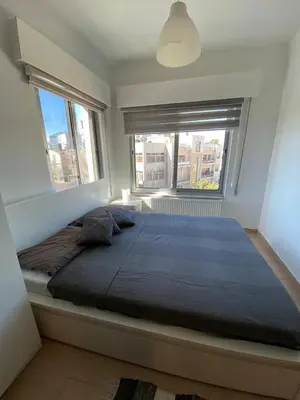 a bedroom with a large bed with a large window at Studio for Rent in Jabal Alweibdeh-Amman - Jordan in Amman