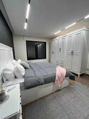 a bedroom with a large bed with a window at Amman Central Comfort in Amman