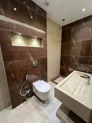 a bathroom with a toilet and a sink at Amman Central Comfort in Amman