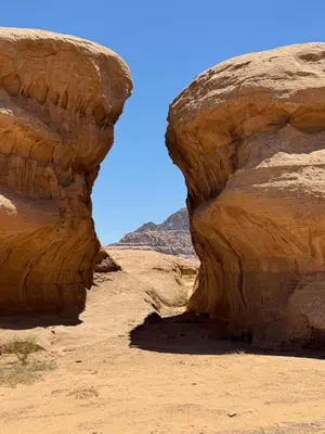 a view of a canyon in the desert at cave under the stars in Wadi Rum