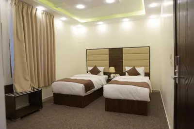 a hotel room with two beds and a mirror at Petra Brothers in Petra