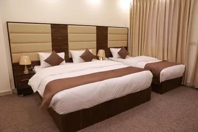 a hotel room with two beds in a room at Petra Brothers in Petra