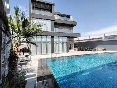 a swimming pool in front of a building at Taj Villa 2 - entire Villa in Deadsea front beach in Sowayma