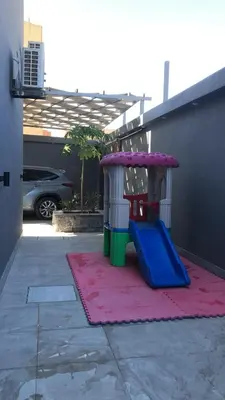 a toy playground with a slide on a sidewalk at Taj Villa 2 - entire Villa in Deadsea front beach in Sowayma