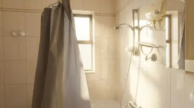 a bathroom with a shower with a shower curtain at Cozy & Spacious 3 En-Suite Bedroom Apartment in Amman