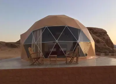 a dome tent with chairs in the desert at Desert yanal wadi rum in Disah