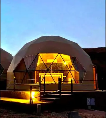 a large dome shaped building with lights on it at Desert yanal wadi rum in Disah