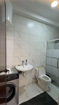 a small bathroom with a toilet and a sink at شقق-روف للايجار اليومي والاسبوعي in Al Qarţū‘īyah