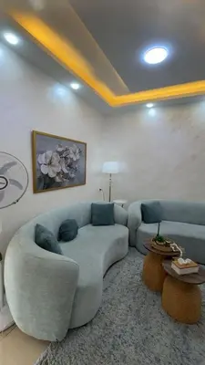 a living room with a couch and a table at شقق-روف للايجار اليومي والاسبوعي in Al Qarţū‘īyah