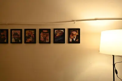 a group of pictures hanging on a wall at AL Majd hostel in Amman