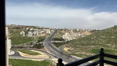a view of a winding road in a city at 3 Bedrooms Flat in Rabwat Abdoun in Amman