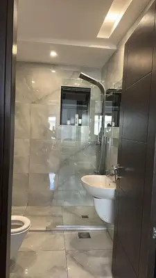 a bathroom with a toilet and a sink at 3 Bedrooms Flat in Rabwat Abdoun in Amman
