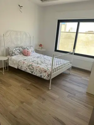 a bedroom with a bed and a window at 3 Bedrooms Flat in Rabwat Abdoun in Amman