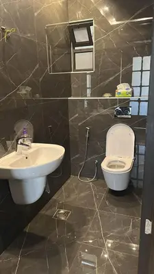 a bathroom with a sink and a toilet at 3 Bedrooms Flat in Rabwat Abdoun in Amman