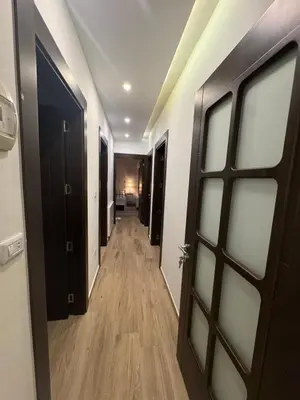 a hallway with a door and a hallway with wood floors at 3 Bedrooms Flat in Rabwat Abdoun in Amman