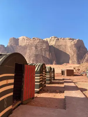 a fence in the desert with a mountain in the background at Nayef camp wadi Rum in Wadi Rum