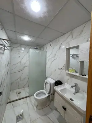 a white bathroom with a toilet and a sink at Isabella Luxury Wadi Rum in Wadi Rum