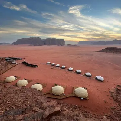 a group of rocks laying in the desert at Super Delxue Tent in Azraq ash Shīshān