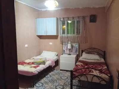 a small room with two beds and a window at Monastery in Wadi Musa
