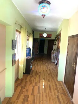 a hallway with a hard wood floor and a chandelier at Monastery in Wadi Musa