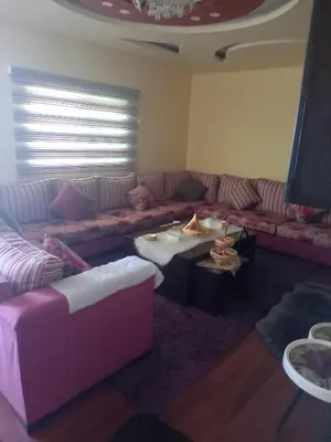 a living room with a couch and a table at Sky apartment in Amman