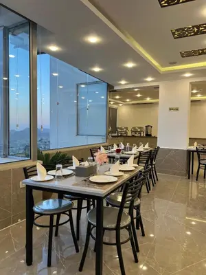 a large dining room with a long table and chairs at The charming view in Wadi Musa