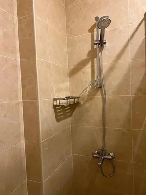 a shower with a shower head in a bathroom at The charming view in Wadi Musa