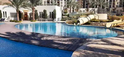 a large swimming pool with a water slide at قرية الراحة باطلالة بحرية-مرسى زايد-Alraha village -marsa zayed- with sea view in Aqaba